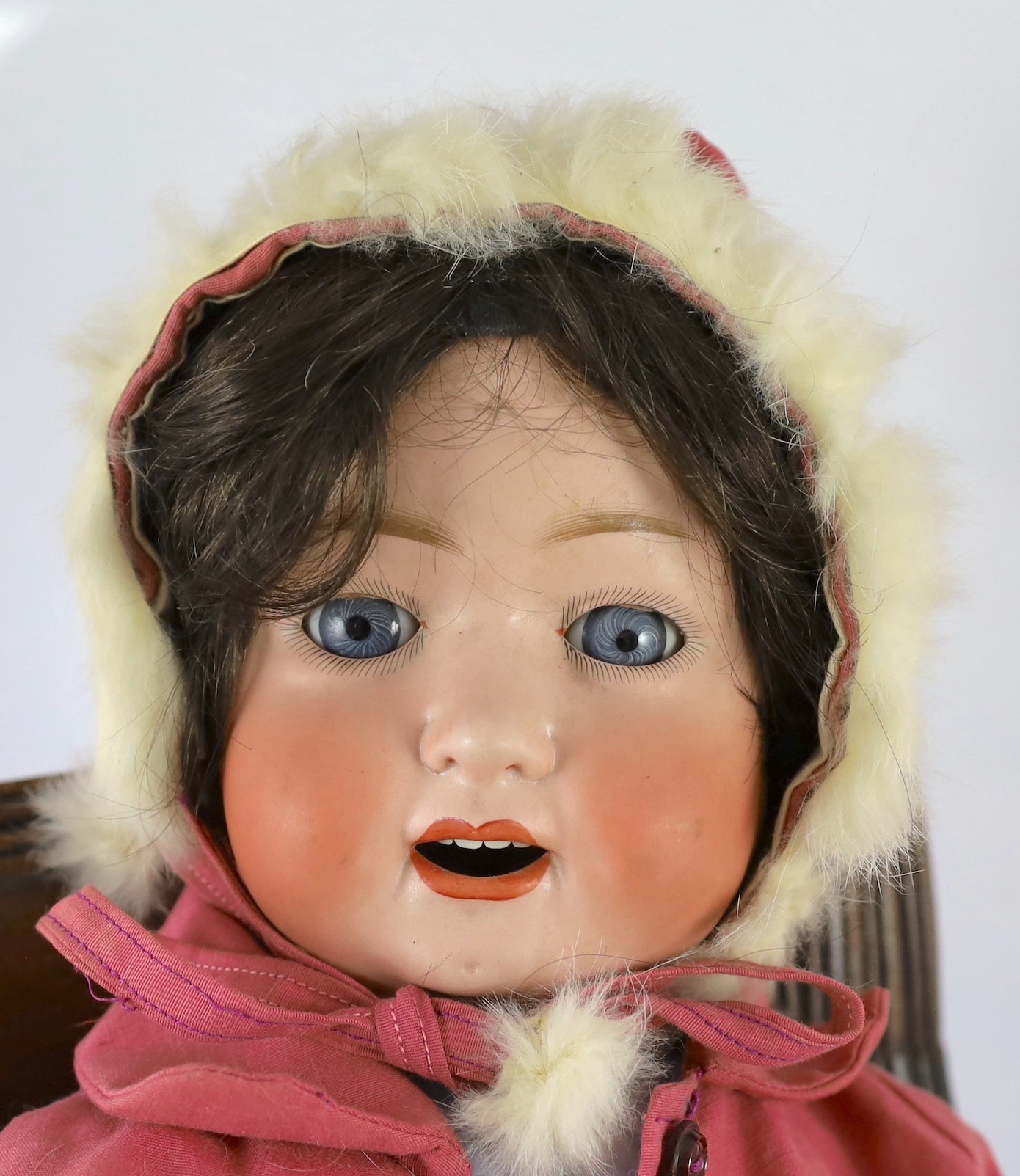 A Heubach Koppelsdorf bisque doll, German, circa 1914, 23in. Please note the chair is for display purposes only.